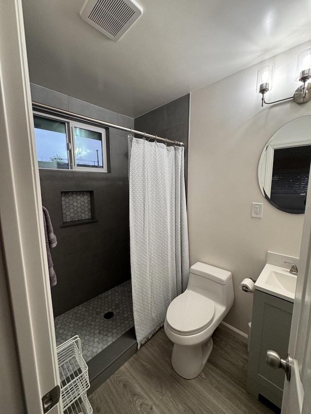 bathroom featuring vanity, wood-type flooring, toilet, and a shower with shower curtain