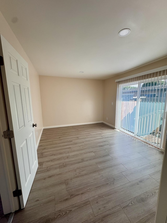 unfurnished room with light hardwood / wood-style floors