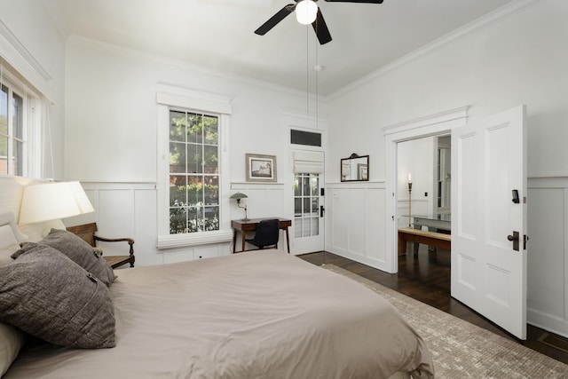 bedroom with crown molding, connected bathroom, ceiling fan, and dark hardwood / wood-style flooring