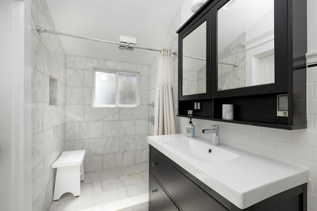 bathroom with tasteful backsplash, vanity, tile walls, and curtained shower