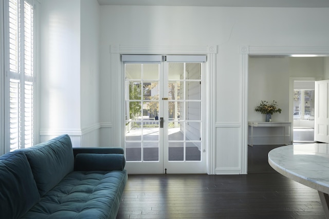 entryway with dark hardwood / wood-style floors, plenty of natural light, and french doors