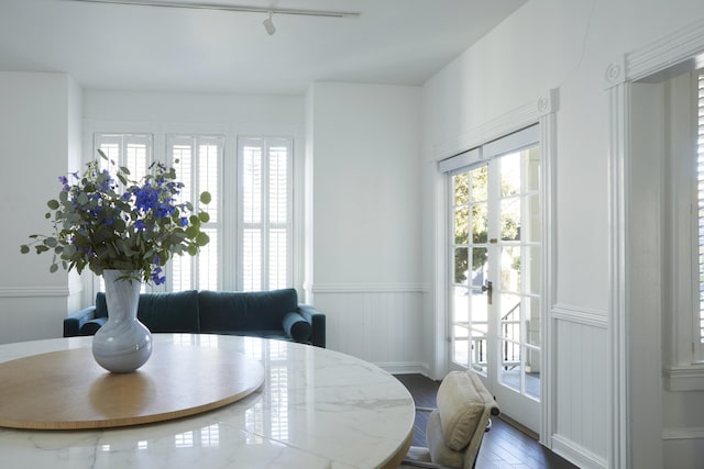 dining area featuring hardwood / wood-style flooring and track lighting