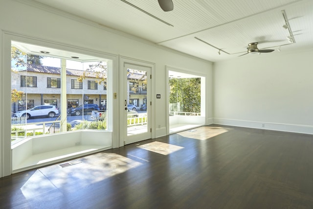 doorway to outside with ceiling fan, dark hardwood / wood-style flooring, and rail lighting