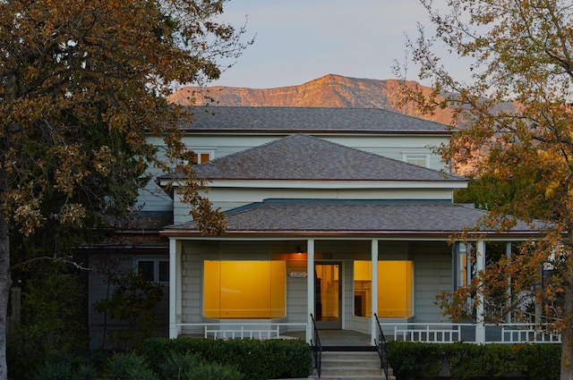 view of front facade with a mountain view and covered porch