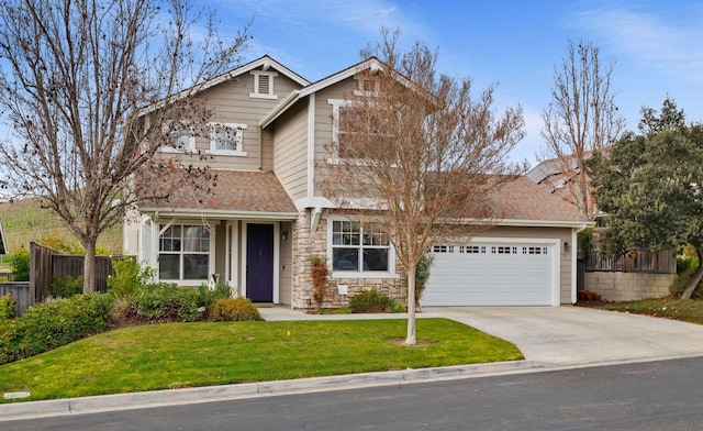 view of front of home featuring a garage and a front yard