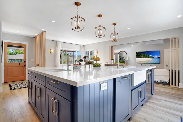 kitchen featuring sink, hanging light fixtures, and a spacious island