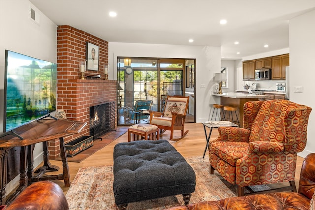 living room featuring a fireplace and light wood-type flooring