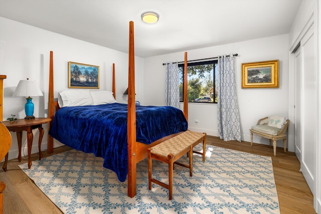 bedroom featuring hardwood / wood-style floors and a closet