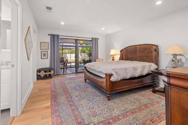 bedroom with access to exterior and light hardwood / wood-style floors