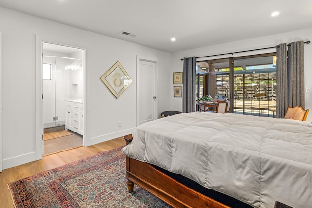 bedroom with multiple windows, connected bathroom, light hardwood / wood-style flooring, and access to outside