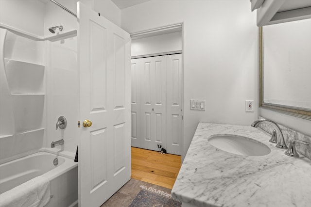 bathroom with wood-type flooring, tub / shower combination, and vanity