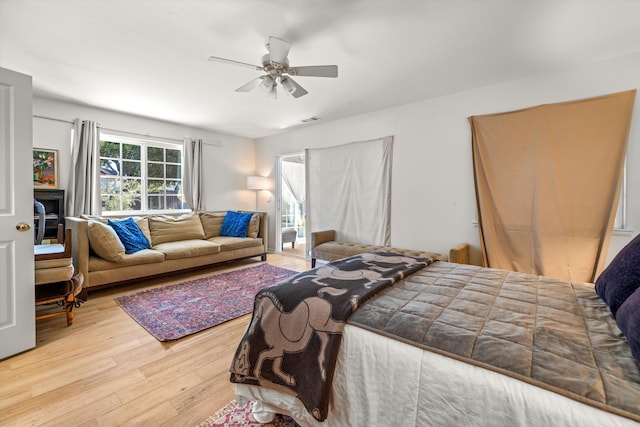 bedroom with light hardwood / wood-style floors and ceiling fan