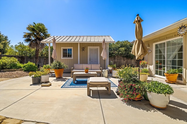 exterior space with an outdoor living space, an outbuilding, and a patio area