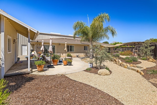 rear view of house featuring a patio and a pergola