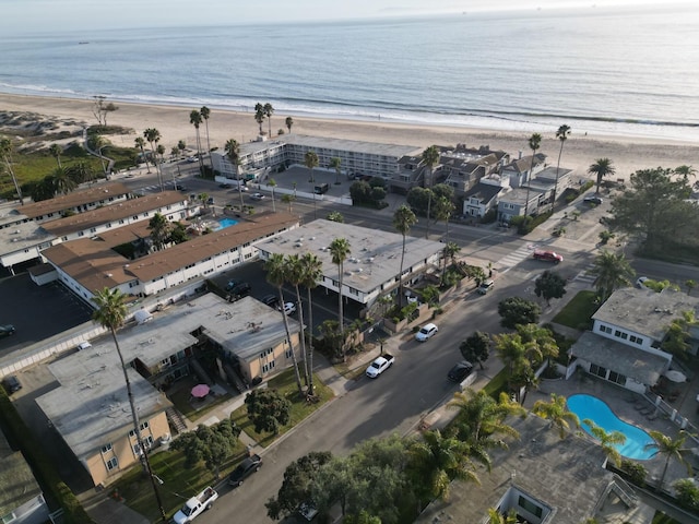 birds eye view of property featuring a water view and a beach view