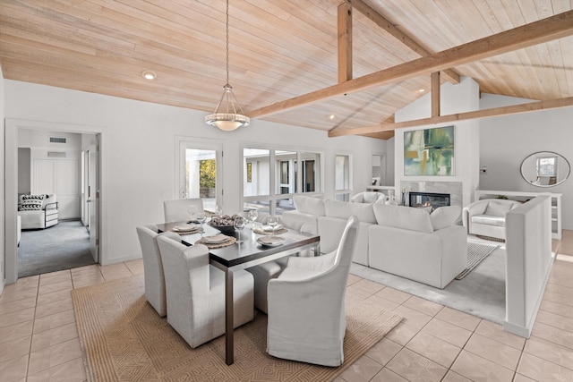 tiled dining area featuring vaulted ceiling with beams and wood ceiling