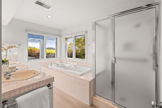 bathroom with vanity, hardwood / wood-style flooring, and separate shower and tub