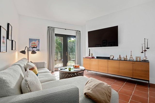 living room featuring dark tile patterned flooring and french doors