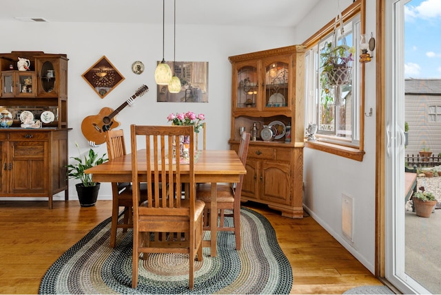 dining space with hardwood / wood-style floors