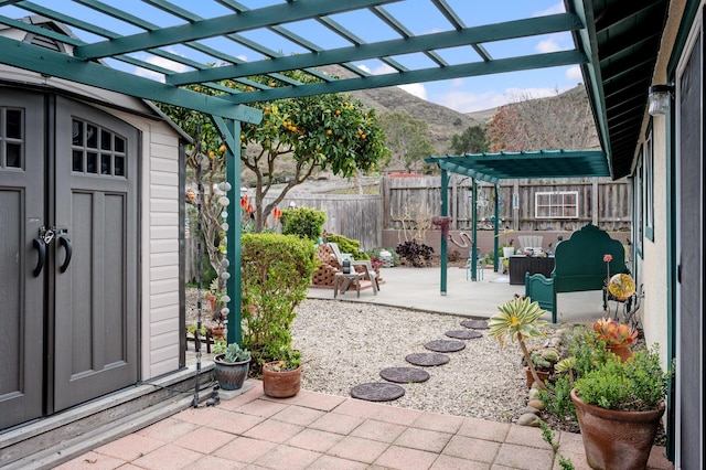 view of patio with an outdoor living space, a mountain view, and a pergola