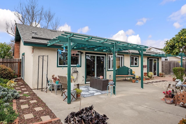 back of property featuring a pergola and a patio area