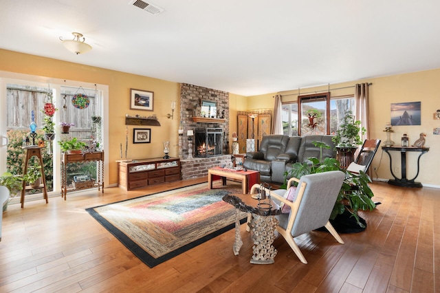 living room with hardwood / wood-style floors and a fireplace