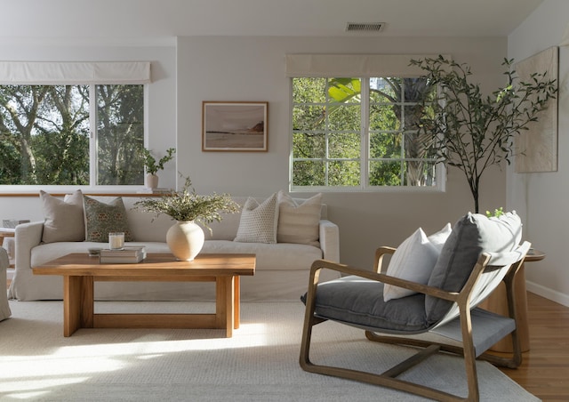 living area with light wood-type flooring and visible vents