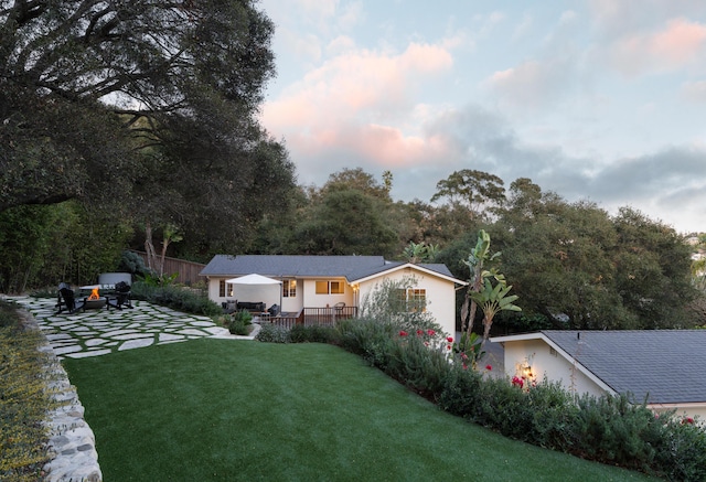 exterior space with a front lawn, a patio area, and fence