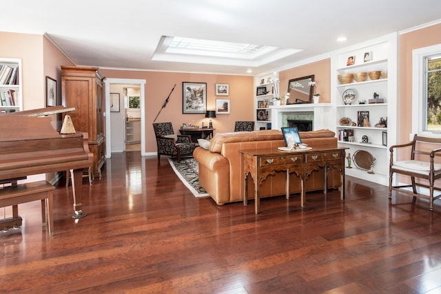 living room featuring crown molding, dark hardwood / wood-style floors, and built in shelves