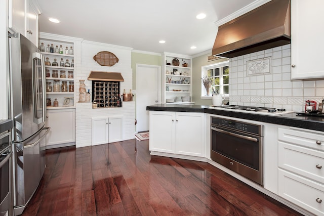 kitchen with dark hardwood / wood-style flooring, custom range hood, white cabinets, and appliances with stainless steel finishes