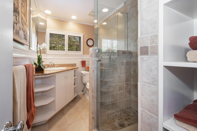 bathroom with a shower with shower door, tile patterned flooring, vanity, toilet, and crown molding