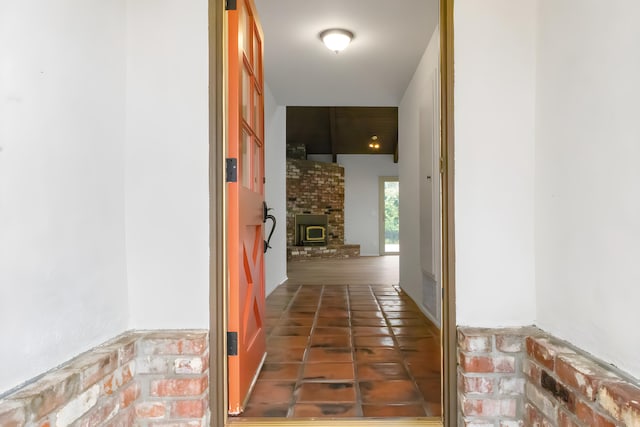 hallway featuring dark tile patterned floors