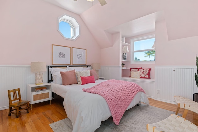 bedroom featuring ceiling fan, vaulted ceiling, and light hardwood / wood-style flooring