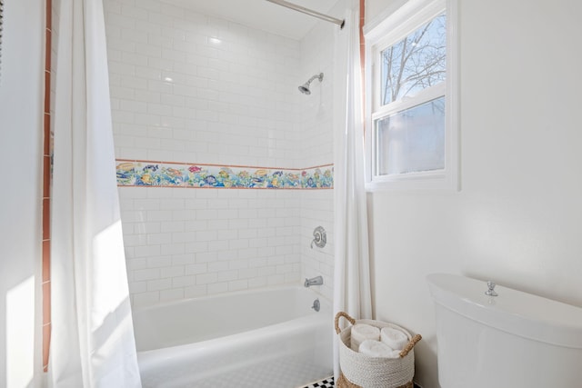 bathroom featuring shower / bath combination with curtain and toilet