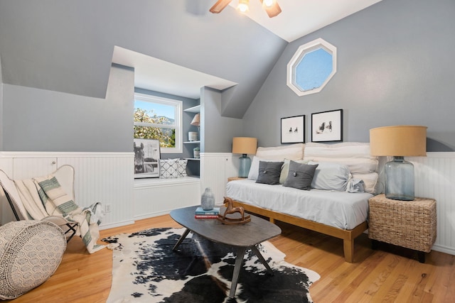 living room with vaulted ceiling, ceiling fan, and light hardwood / wood-style floors