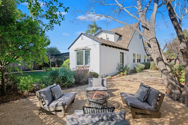 back of property featuring a patio area and an outdoor fire pit