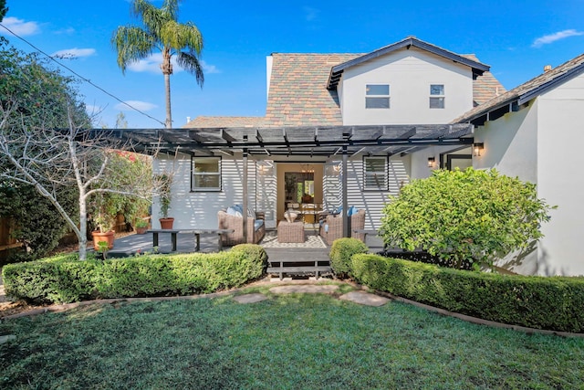 rear view of property featuring an outdoor hangout area, a pergola, a lawn, and a wooden deck