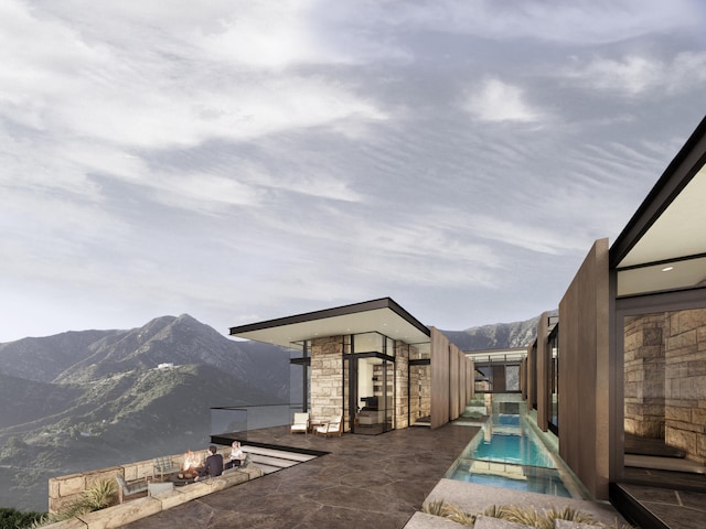 view of pool with a mountain view and an in ground hot tub