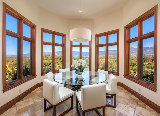 dining area with a mountain view and a high ceiling