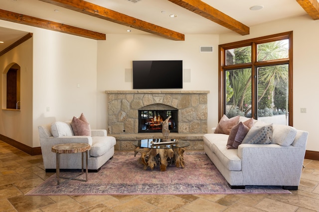 living room with beam ceiling and a fireplace