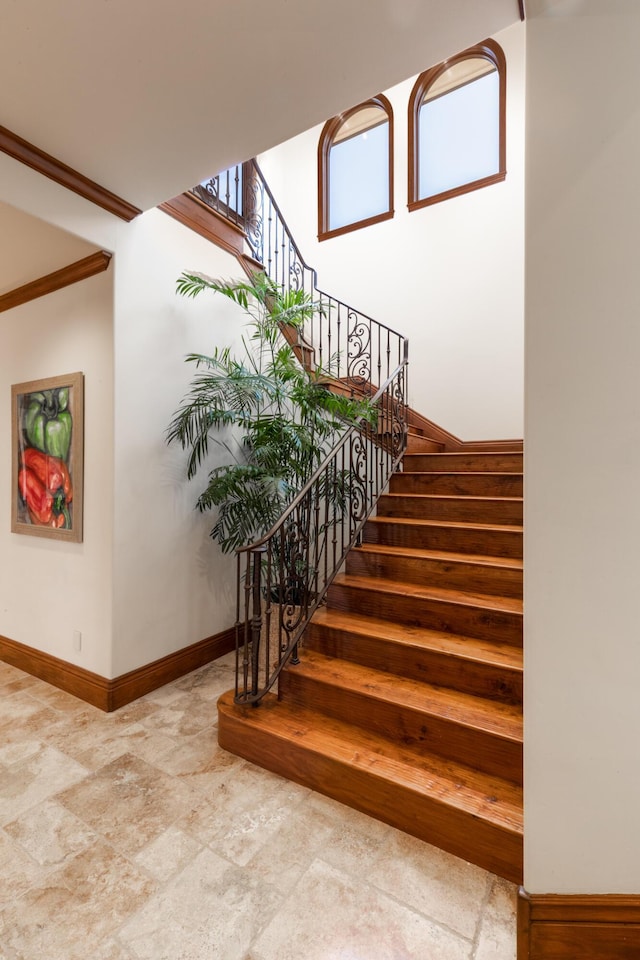 staircase featuring crown molding