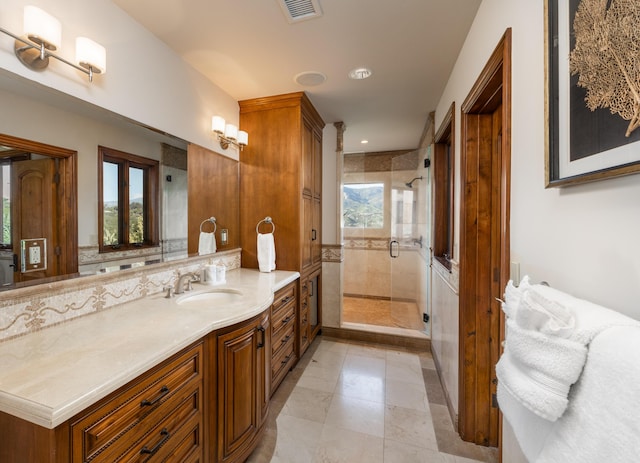 bathroom with vanity, plenty of natural light, and walk in shower