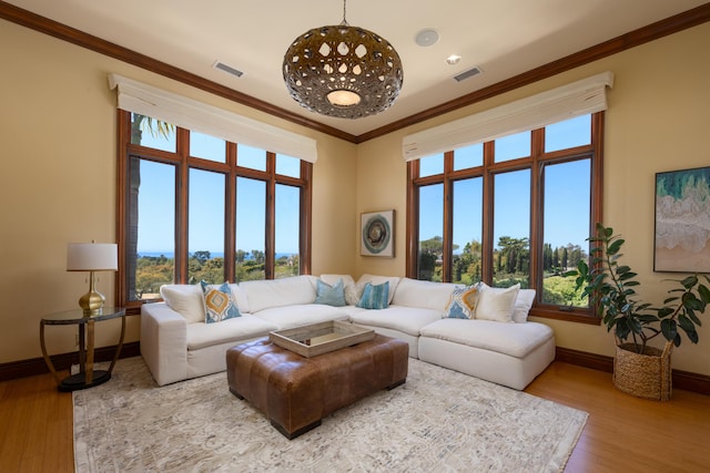 living room with crown molding and hardwood / wood-style floors