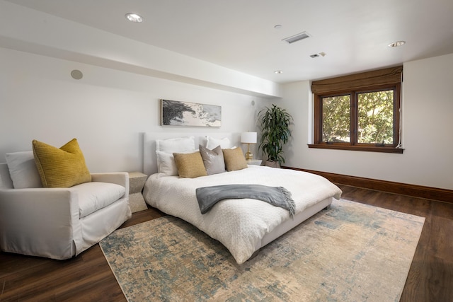 bedroom with dark hardwood / wood-style floors