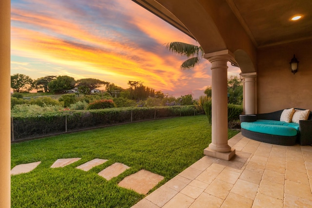 yard at dusk featuring a patio area