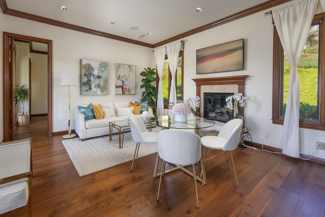 living room with ornamental molding, dark hardwood / wood-style flooring, and a high end fireplace