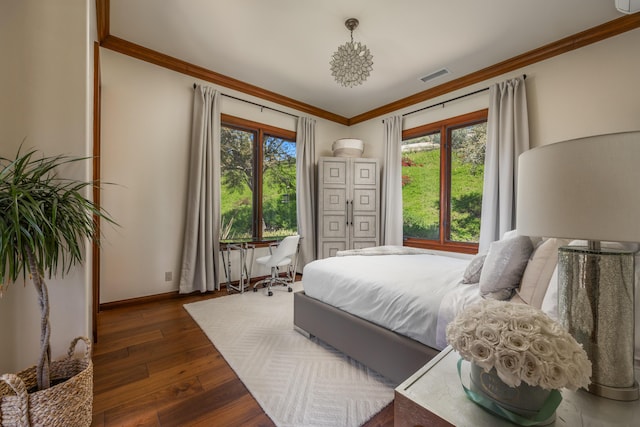 bedroom with ornamental molding and dark hardwood / wood-style floors