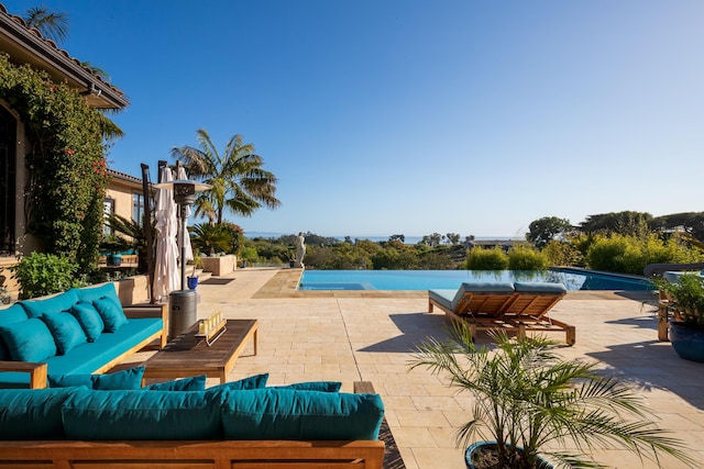 view of pool with an outdoor living space and a patio