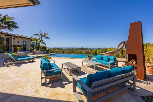 view of patio / terrace with an outdoor living space with a fireplace