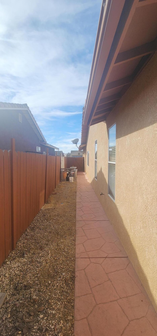 view of side of home featuring a patio area